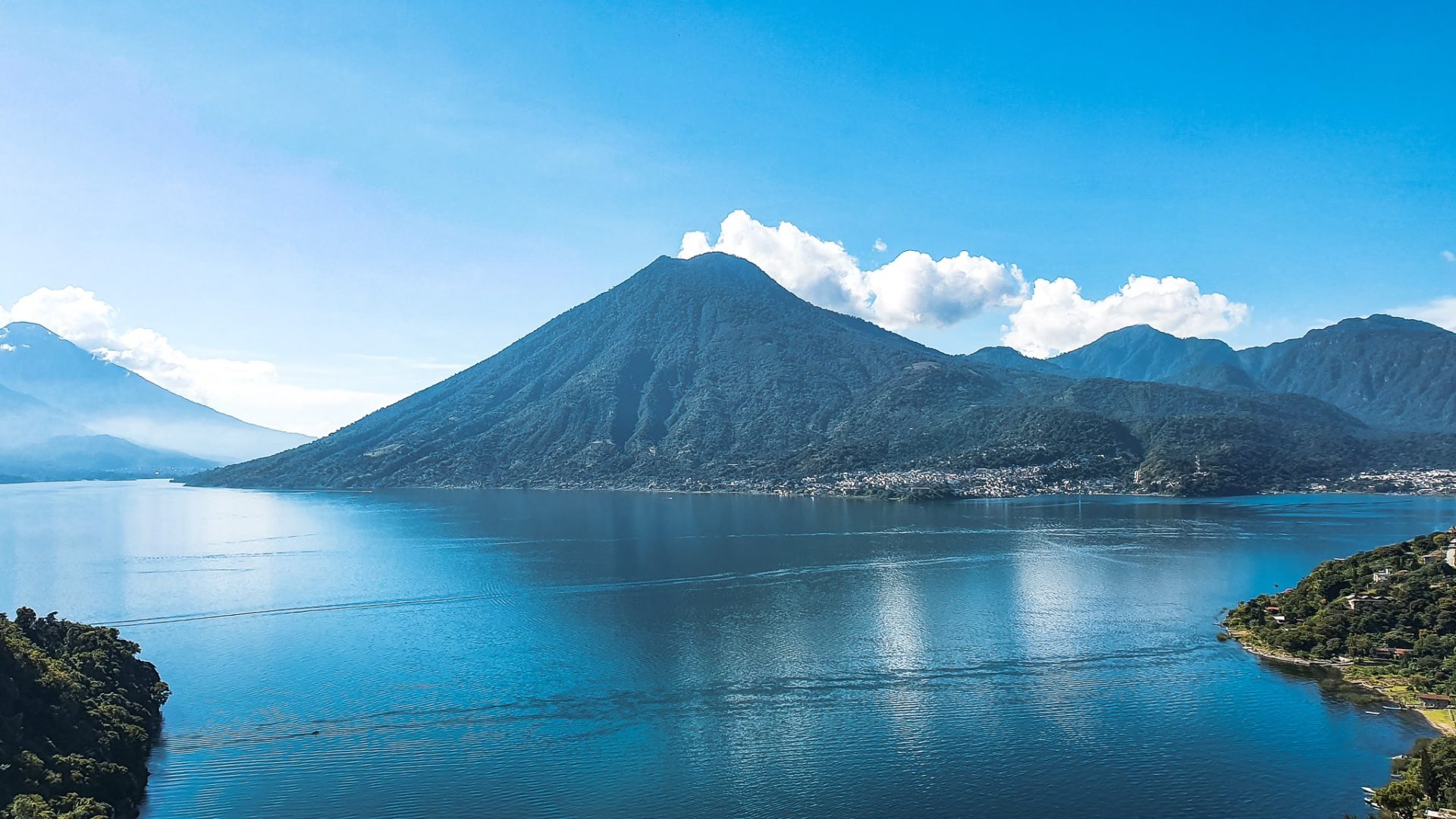 Lake Atitlán volcano landscape at The Cocoon Healing Retreat Guatemala, still blue water reflecting sacred mountains